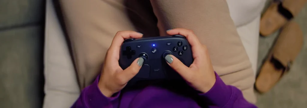 Controller being used by a person on a sofa.